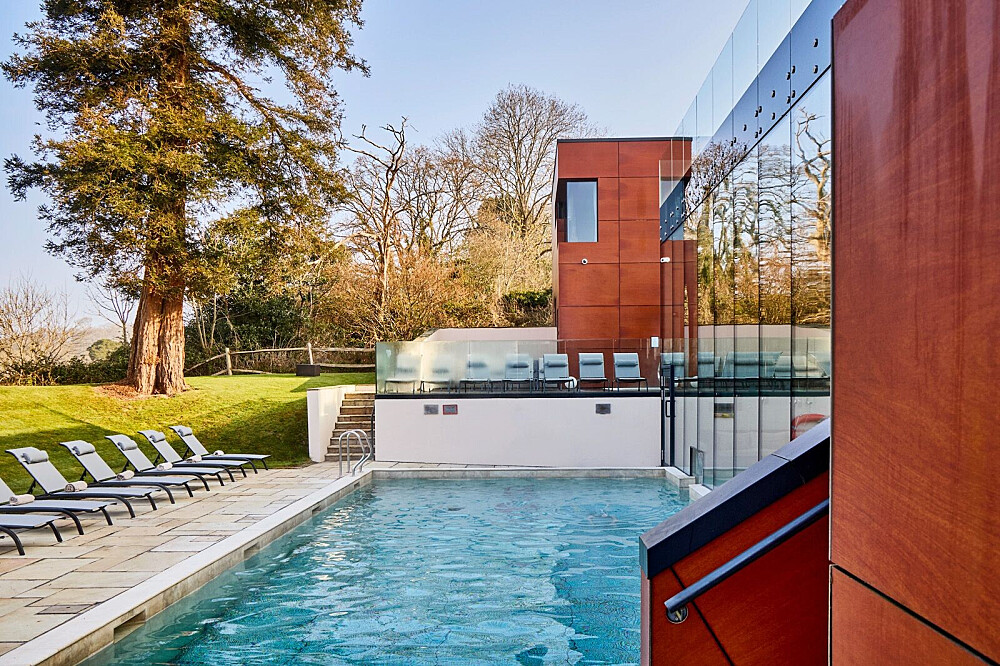 Modern home with glass walls and pool