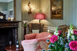 Cozy living room with fireplace and pink sofa