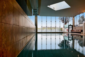 Modern indoor pool with floor-to-ceiling windows