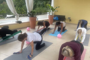 Women exercising with resistance bands on outdoor terrace