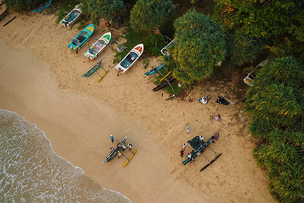 Aerial view of boats on tropical sandy beach