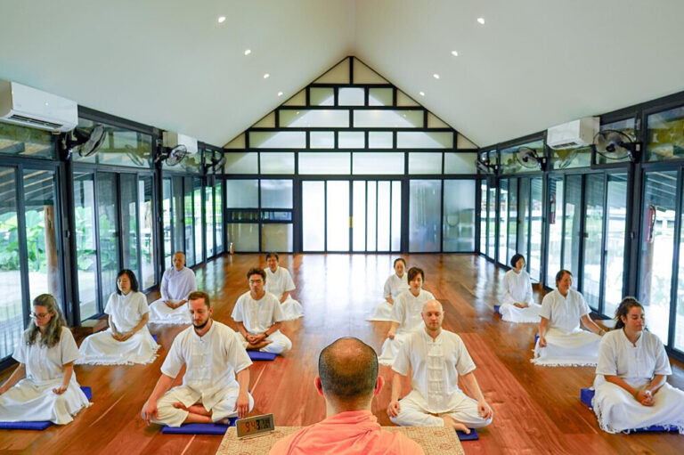 Group meditation class in bright modern hall