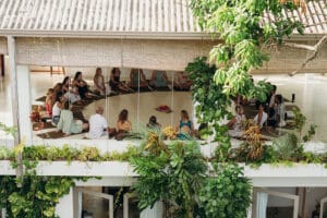 Group meditation session in open-air tropical pavilion