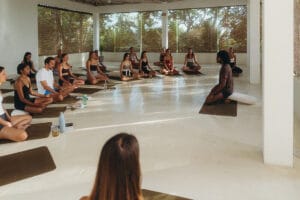 Yoga class seated in meditation with instructor