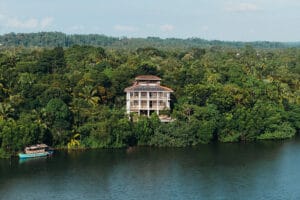 Tropical riverside villa surrounded by lush green forest