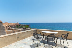 Ocean-view terrace with table and chairs
