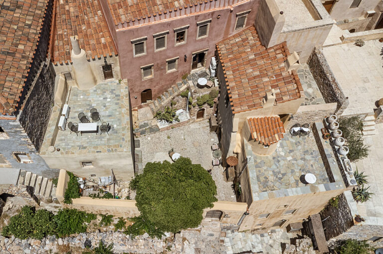 Aerial view of Mediterranean stone buildings with courtyards