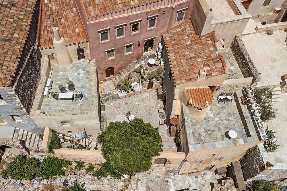 Aerial view of Mediterranean stone buildings with courtyards