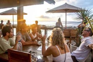 Friends dining at seaside restaurant during sunset