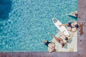 Four people relaxing in clear swimming pool