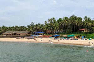 Tropical beach with palm trees and umbrellas