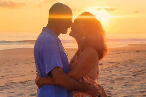 Couple embracing at sunset on the beach