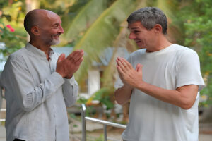 Two men greeting with palms together outdoors