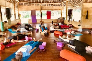 Group yoga class resting in open-air studio