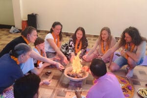 Group performing Hindu fire ritual indoors