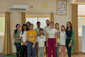 Group posing together in a yoga studio