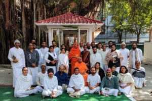 Group posing with leader in orange robes
