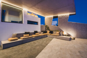 Modern outdoor patio with built-in seating at dusk