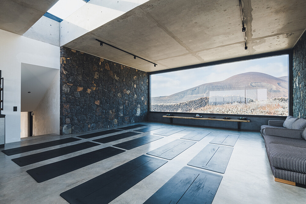Modern yoga studio with mountain view window